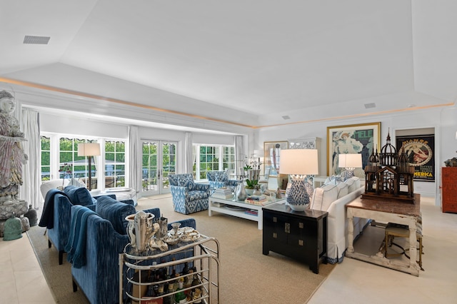 living room featuring a raised ceiling and french doors