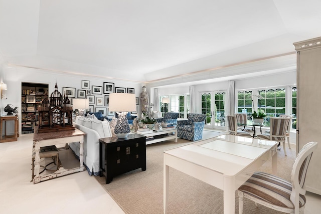 living room featuring a raised ceiling and french doors