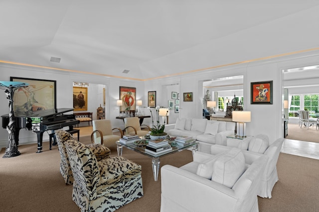 living room featuring light colored carpet and vaulted ceiling