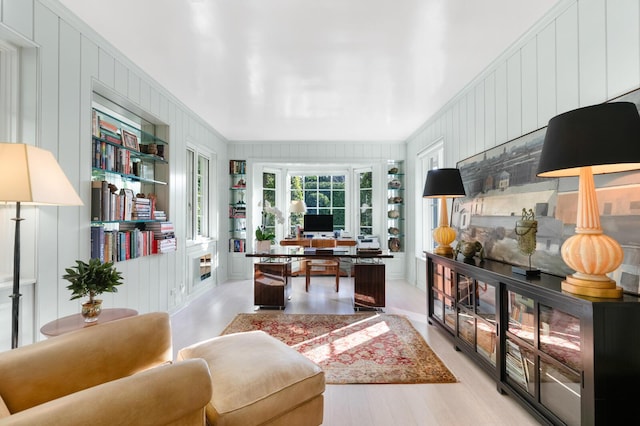 office area featuring wooden walls and crown molding