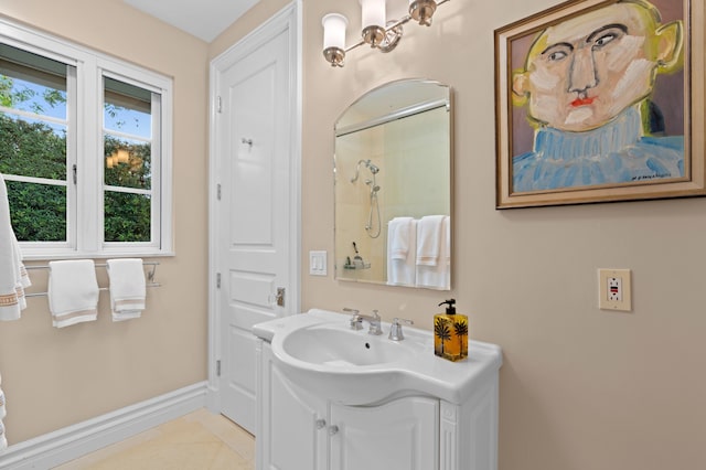 bathroom featuring tile patterned flooring, vanity, and walk in shower