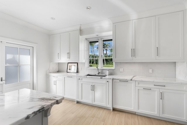 kitchen featuring backsplash, white cabinetry, and sink