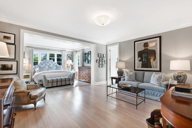 bedroom featuring crown molding and light hardwood / wood-style floors