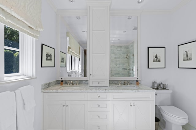 bathroom with crown molding, a shower with door, vanity, and toilet