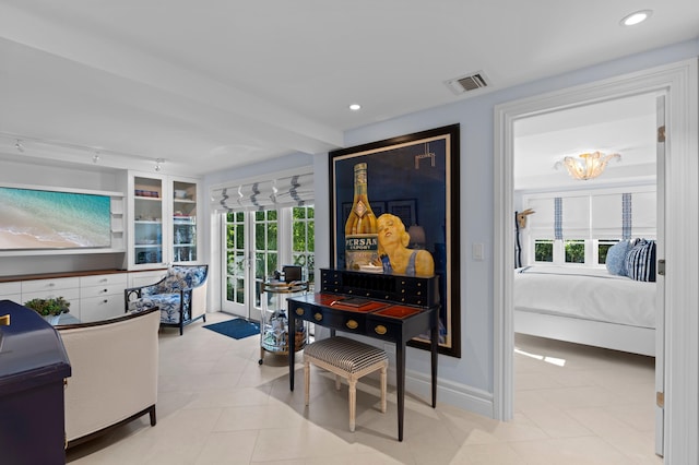 dining room featuring built in shelves, a wealth of natural light, light tile patterned floors, and an inviting chandelier