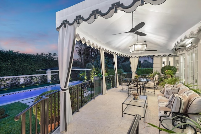 patio terrace at dusk featuring outdoor lounge area and ceiling fan