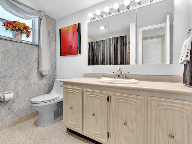 bathroom featuring vanity, toilet, and tile patterned flooring