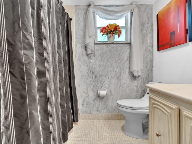 bathroom featuring a shower with curtain, vanity, toilet, and tile patterned flooring