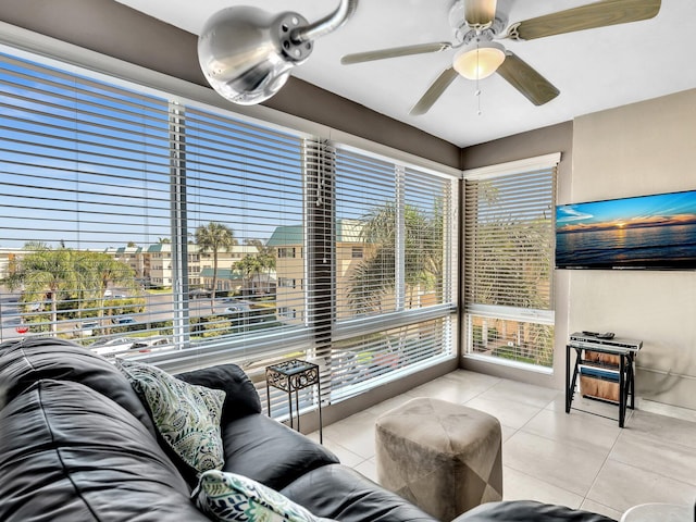 tiled living room with a wealth of natural light and ceiling fan