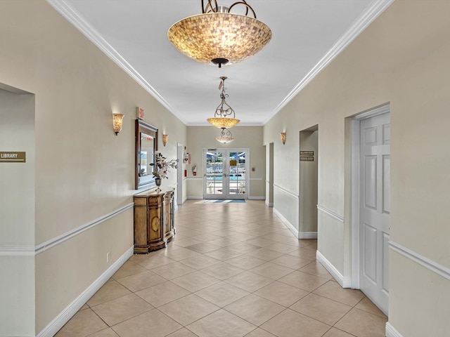 hallway with light tile patterned floors, ornamental molding, and french doors