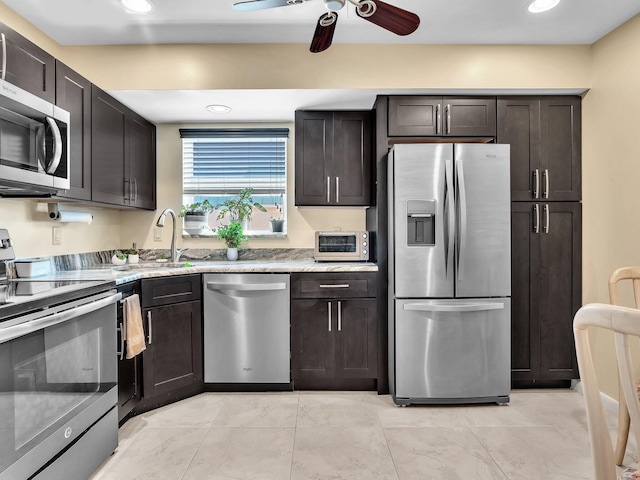 kitchen with stainless steel appliances, dark brown cabinets, sink, and ceiling fan