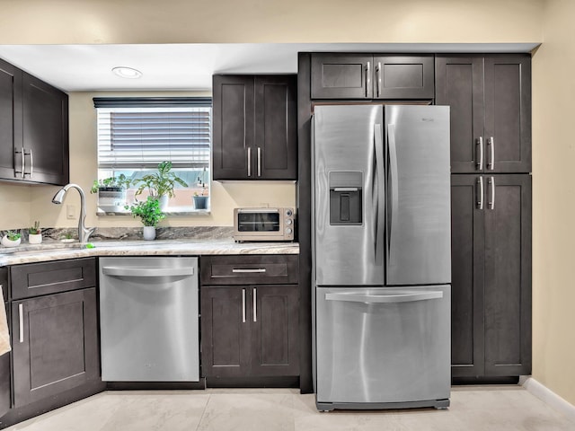 kitchen featuring stainless steel appliances, sink, and dark brown cabinetry