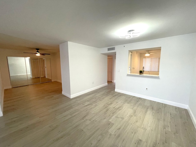 unfurnished room with light wood-type flooring