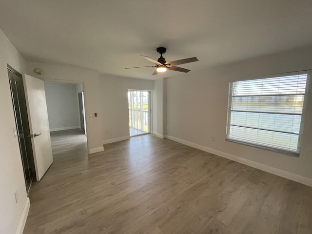 spare room with ceiling fan and hardwood / wood-style floors