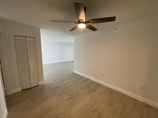 spare room featuring light hardwood / wood-style floors and ceiling fan