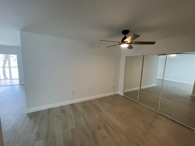 unfurnished bedroom featuring a closet, light hardwood / wood-style flooring, and ceiling fan