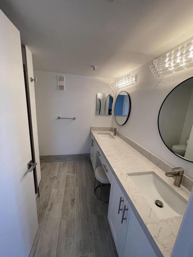 bathroom featuring vanity and toilet