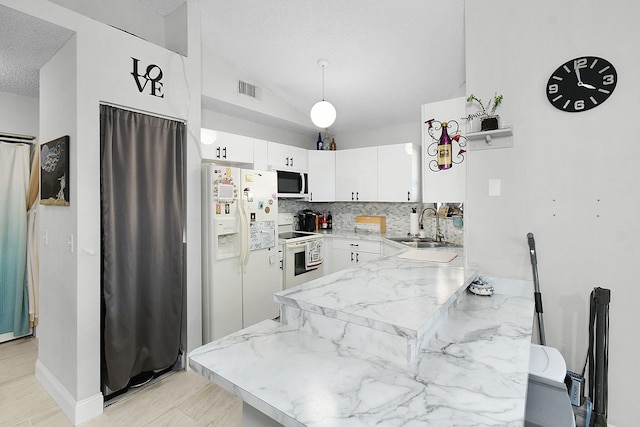 kitchen featuring tasteful backsplash, sink, white appliances, a textured ceiling, and white cabinets