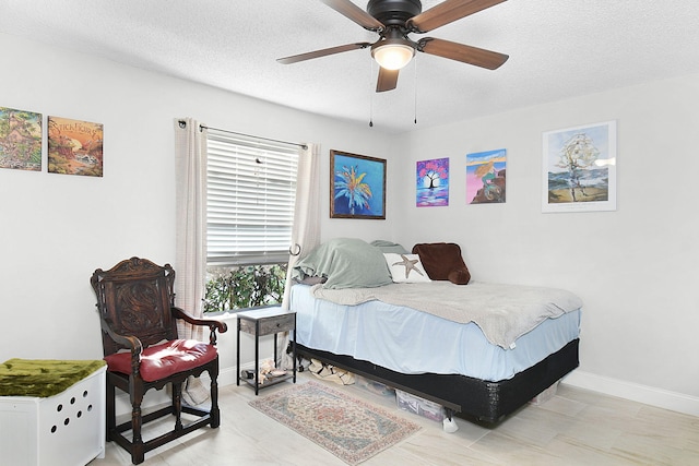 bedroom with a textured ceiling and ceiling fan