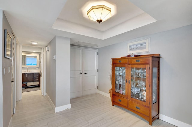 corridor featuring a tray ceiling