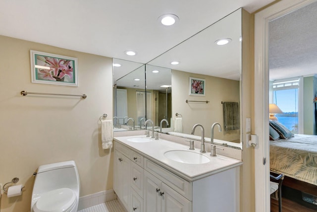 bathroom featuring toilet, tile patterned floors, and vanity