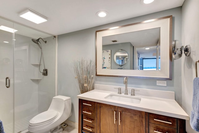 bathroom with toilet, vanity, and walk in shower