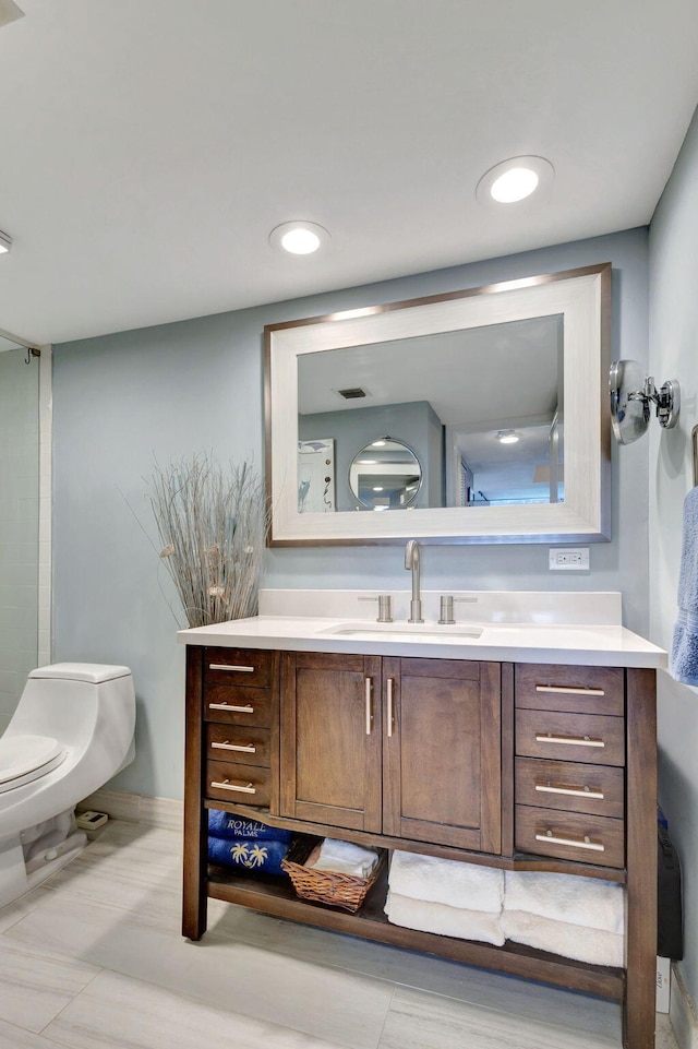 bathroom with toilet and vanity