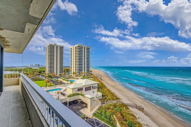 balcony with a beach view and a water view