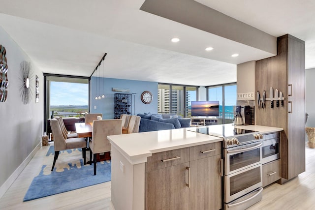 kitchen with double oven range and light hardwood / wood-style floors