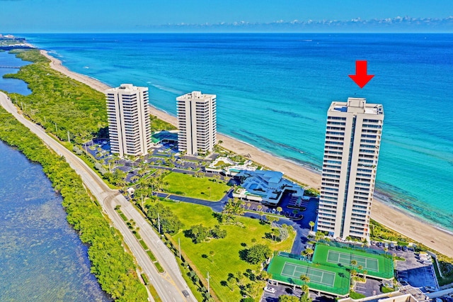 drone / aerial view featuring a water view and a beach view