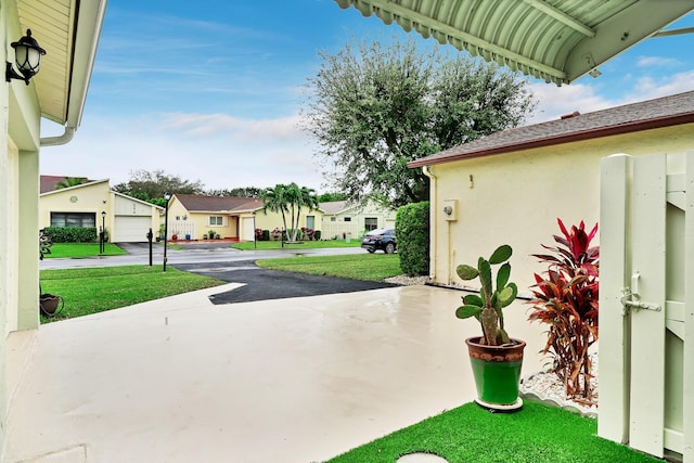 view of patio / terrace featuring a garage and an outbuilding