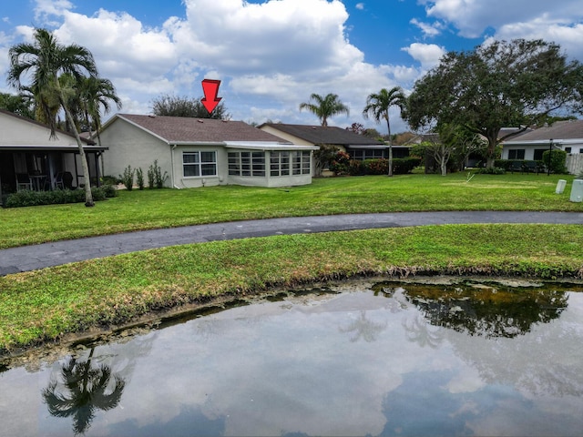 view of front of property with a front lawn and a sunroom