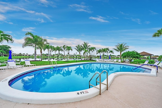 view of swimming pool featuring a water view