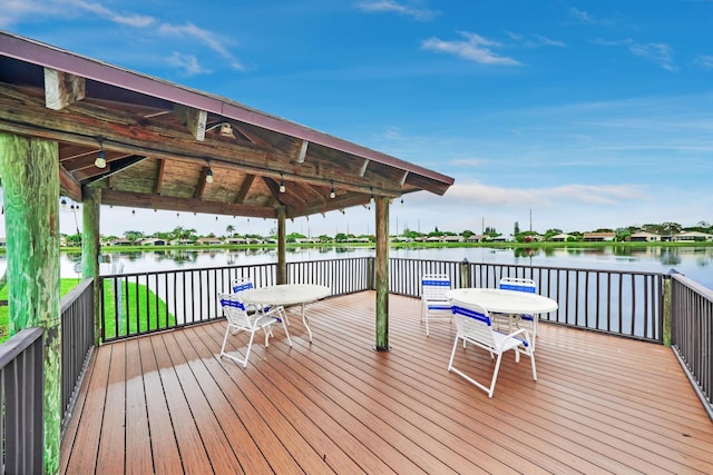 wooden deck featuring a gazebo and a water view