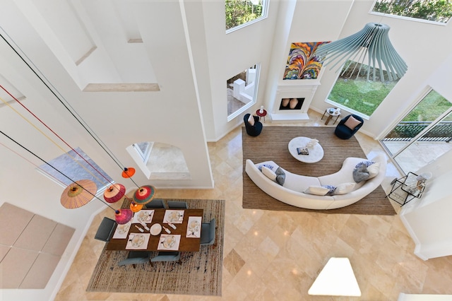 tiled living room with plenty of natural light and a high ceiling