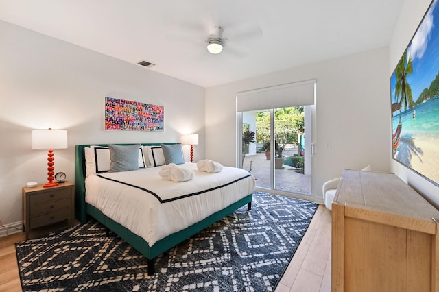 bedroom with ceiling fan, access to exterior, and wood-type flooring