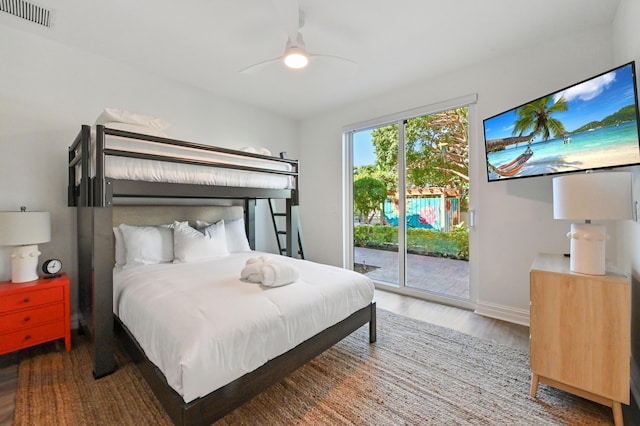 bedroom with access to exterior, ceiling fan, and dark wood-type flooring