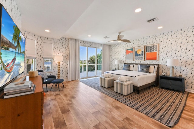 bedroom featuring access to exterior, ceiling fan, and wood-type flooring