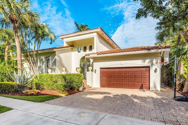 mediterranean / spanish home featuring a garage