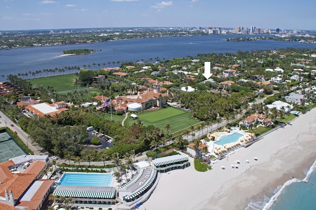 birds eye view of property with a water view and a view of the beach