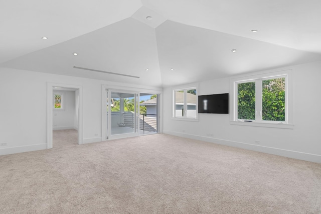 unfurnished living room featuring light colored carpet and vaulted ceiling