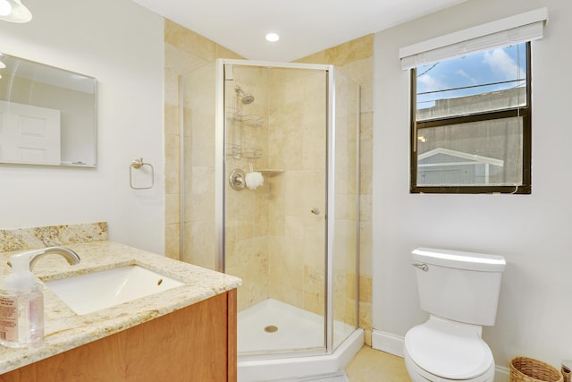 bathroom with vanity, toilet, and an enclosed shower