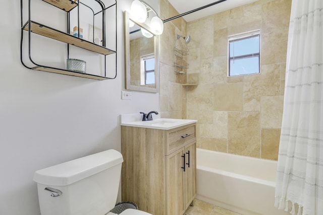 full bathroom with a wealth of natural light, shower / tub combo with curtain, vanity, and toilet