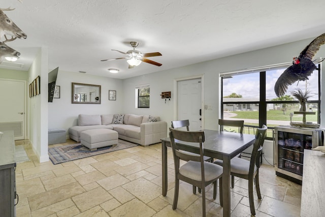 dining room featuring beverage cooler and ceiling fan