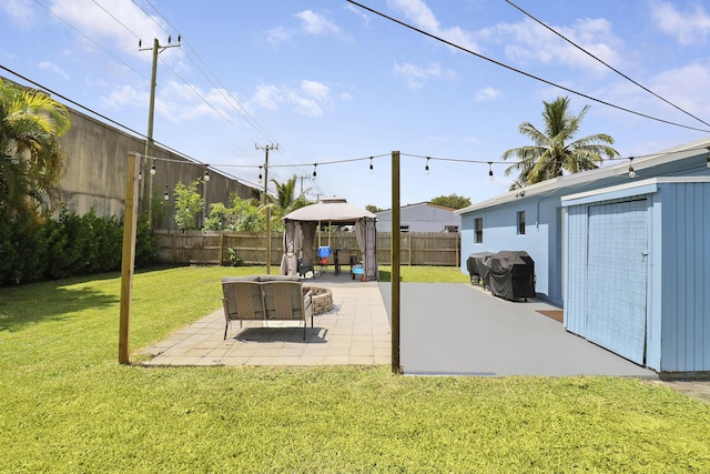 view of yard with an outbuilding, a gazebo, and a patio