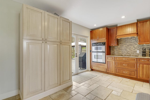 kitchen featuring double oven, black electric cooktop, and decorative backsplash