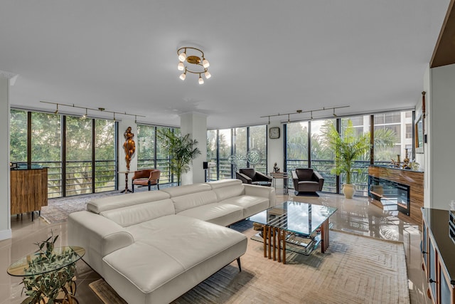 tiled living room featuring a chandelier and a wall of windows