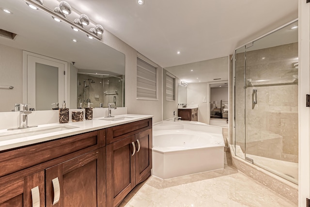 bathroom featuring vanity and shower with separate bathtub