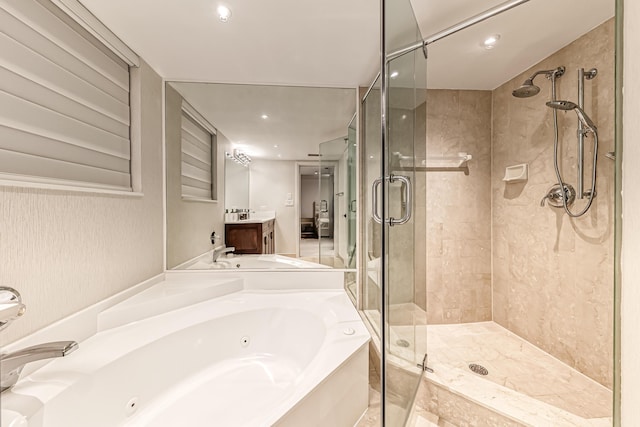 bathroom featuring vanity and independent shower and bath