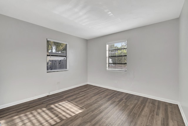 spare room featuring dark wood-type flooring